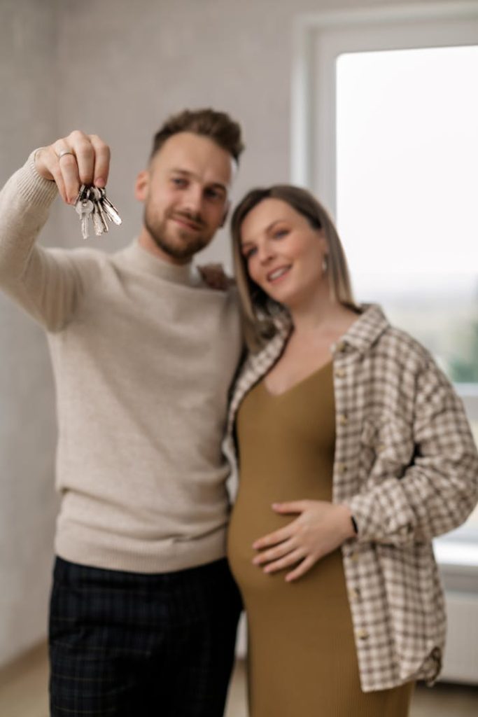 pexels-photo-7641902 A joyful couple celebrating buying their new home, holding keys.